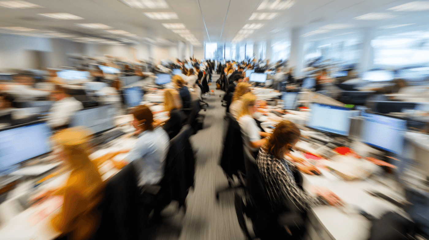 Busy office with many employees working.